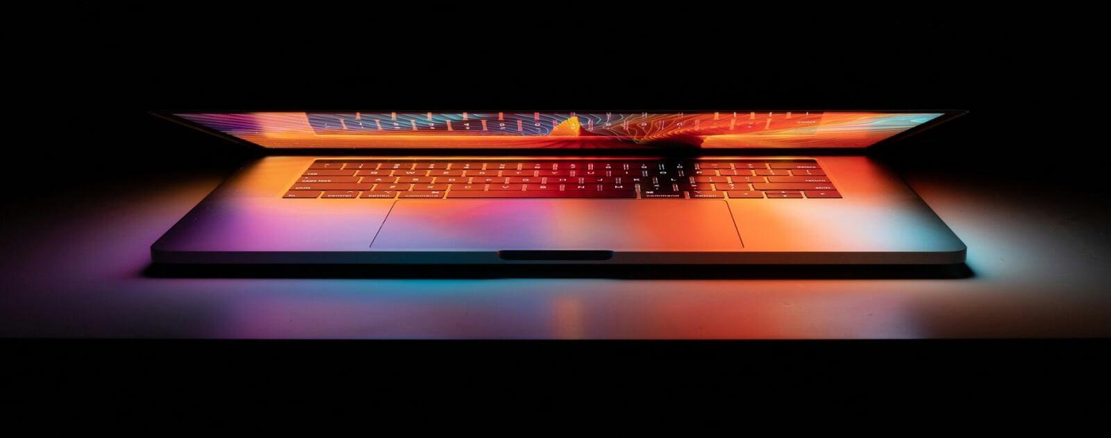 macbook slightly opened with apple intelligence hue